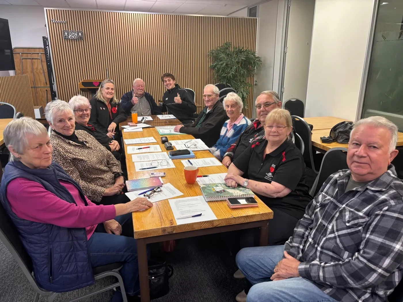 Chase from Tauranga Boys College with members around the meeting table at the Tauranga RSA