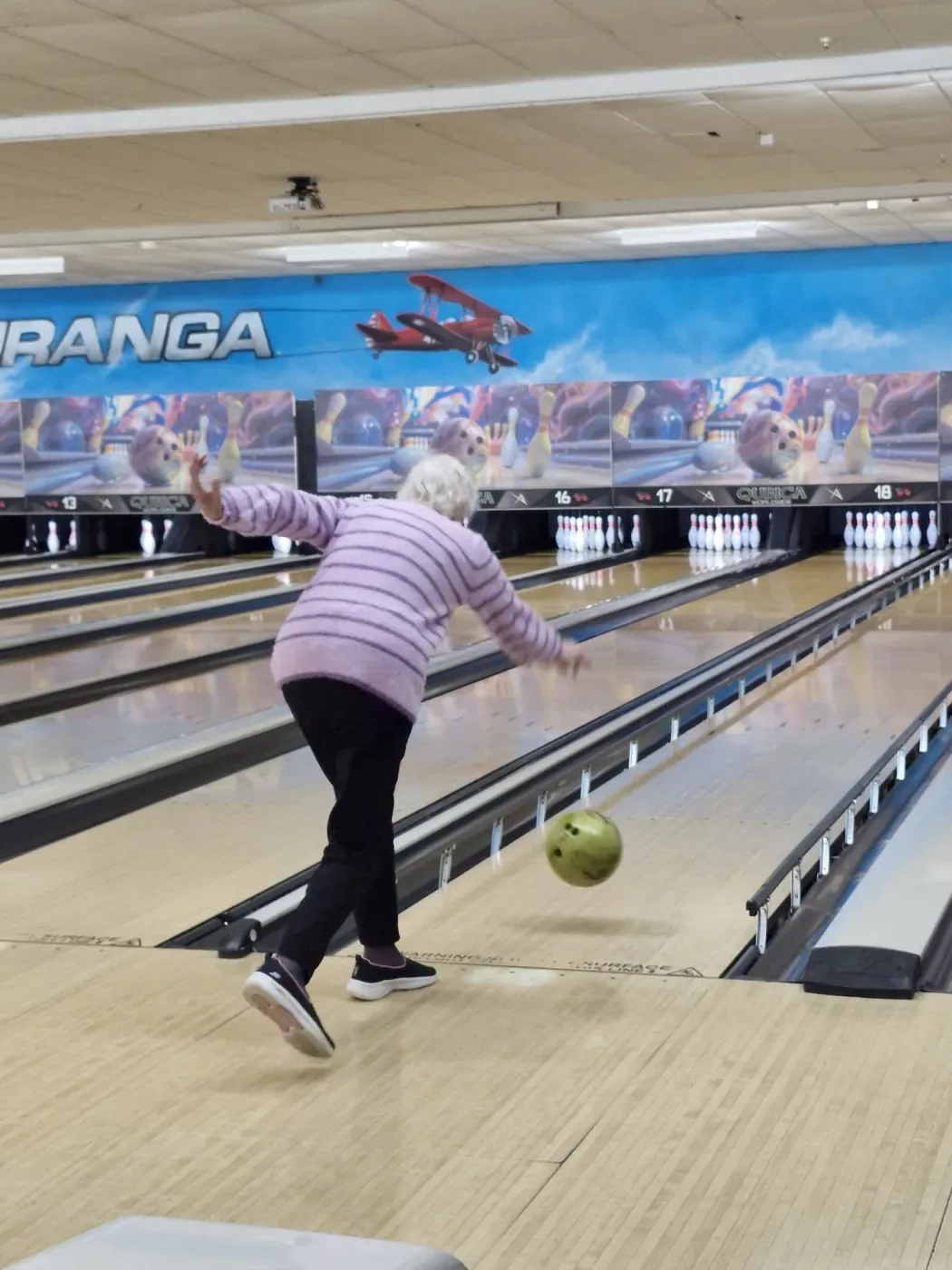 Heather mid-delivery on the bowling lane